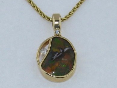 Boulder opal pendant in a yellow gold bezel