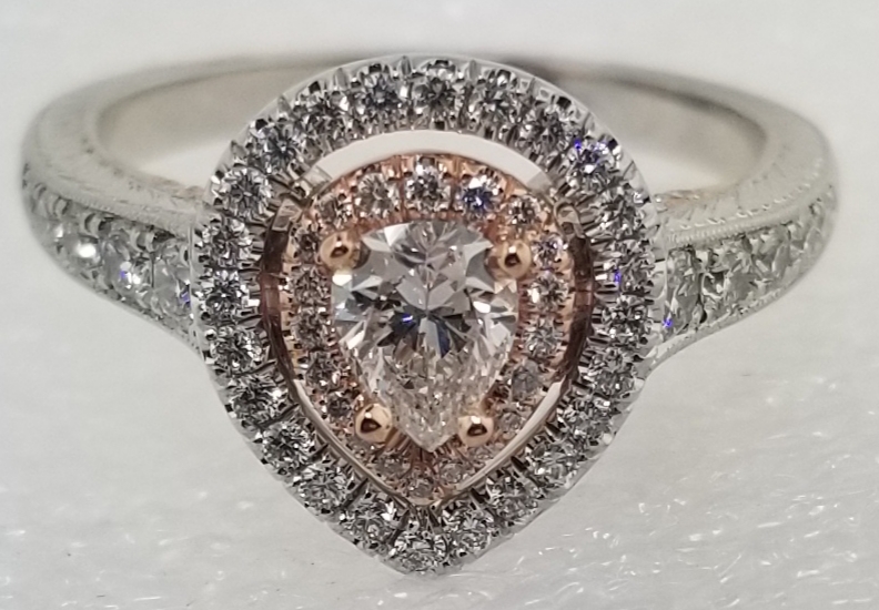 Custom pear-shaped diamond double-halo engagement ring with rose gold accents, made by Nunez Fine Jewelers